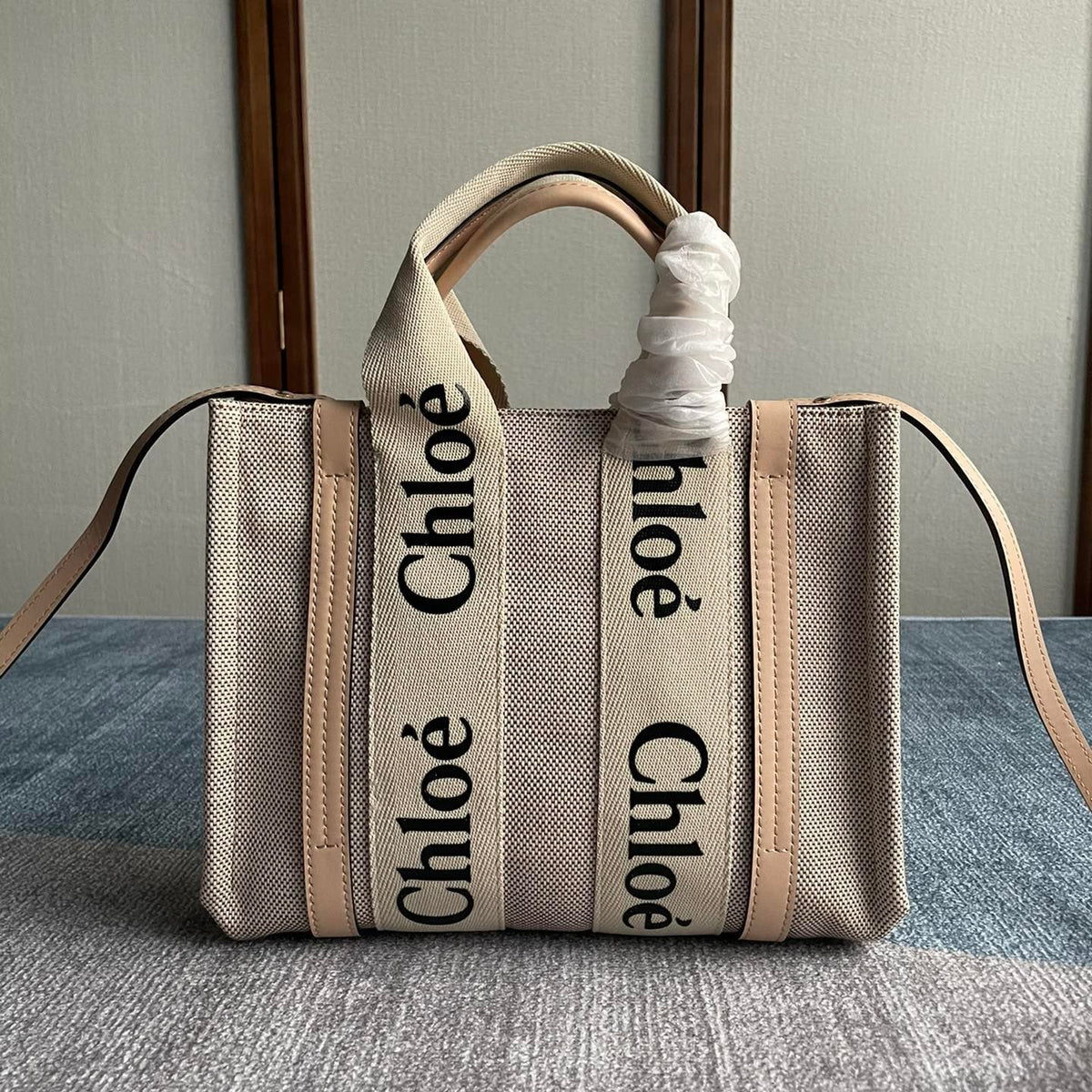 Small Strap Woody Tote Bag 26.5 in Beige Linen Canvas Black Webbing Logo Embroider Nude Calfskin