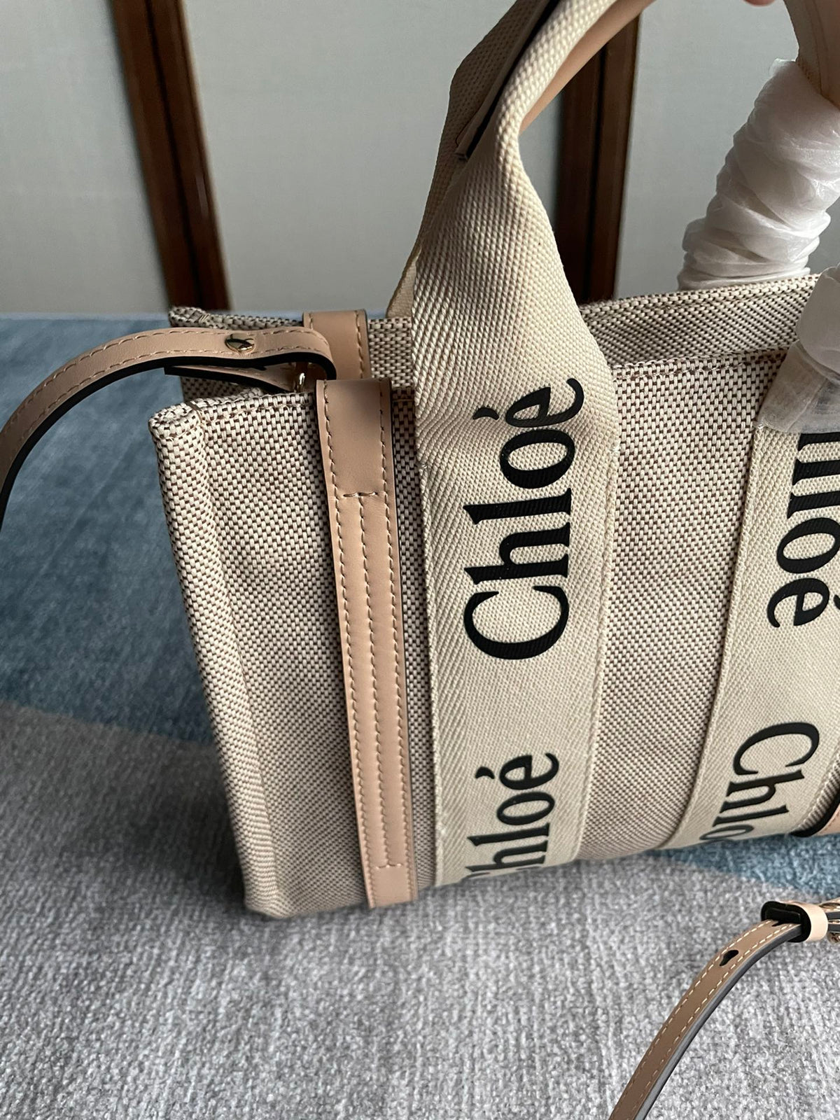 Small Strap Woody Tote Bag 26.5 in Beige Linen Canvas Black Webbing Logo Embroider Nude Calfskin