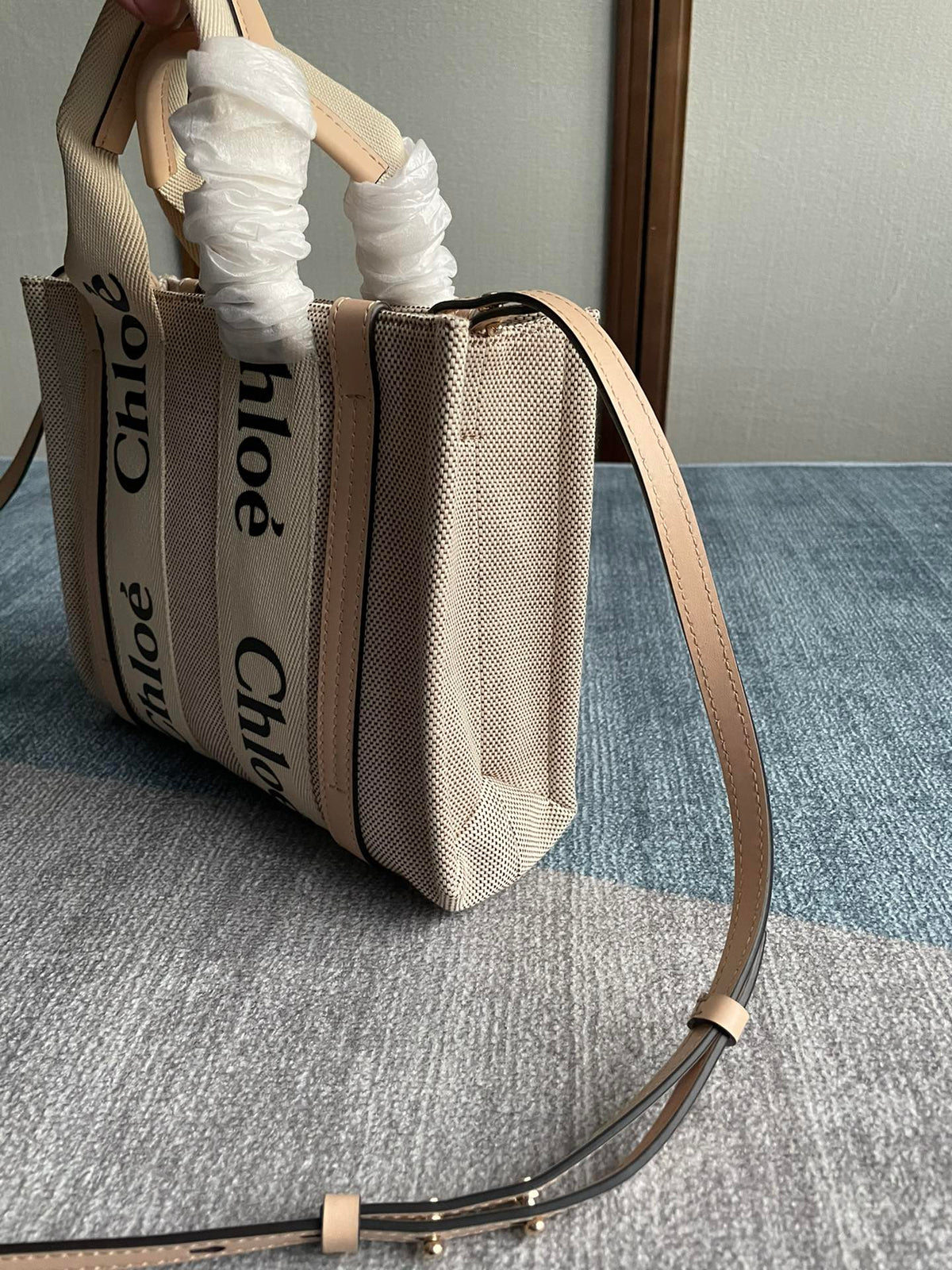 Small Strap Woody Tote Bag 26.5 in Beige Linen Canvas Black Webbing Logo Embroider Nude Calfskin