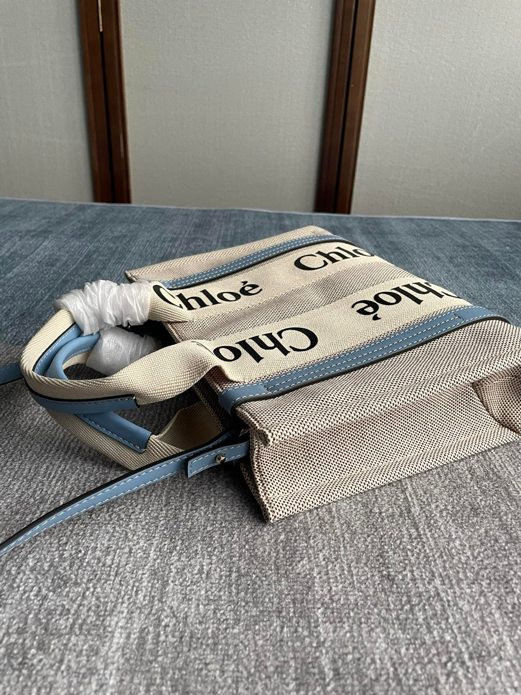 Small Strap Woody Tote Bag 26.5 in Beige Linen Canvas Black Webbing Logo Embroider Blue Calfskin