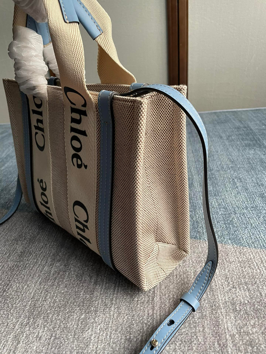 Small Strap Woody Tote Bag 26.5 in Beige Linen Canvas Black Webbing Logo Embroider Blue Calfskin