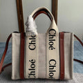 Small Strap Woody Tote Bag 26.5 in Beige Linen Canvas Black Webbing Logo Embroider Brown Calfskin