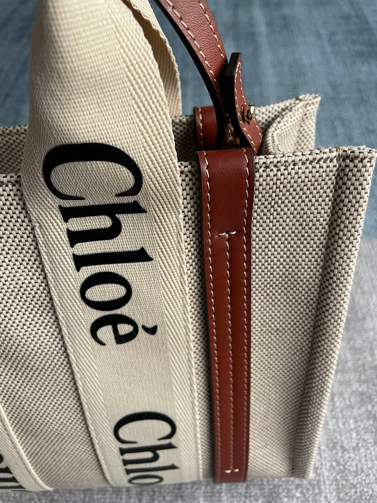 Small Strap Woody Tote Bag 26.5 in Beige Linen Canvas Black Webbing Logo Embroider Brown Calfskin
