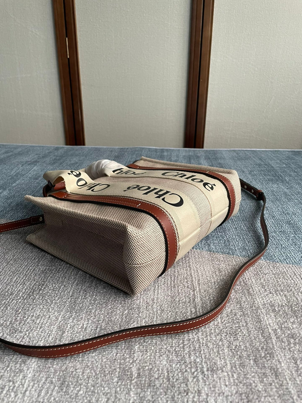 Small Strap Woody Tote Bag 26.5 in Beige Linen Canvas Black Webbing Logo Embroider Brown Calfskin