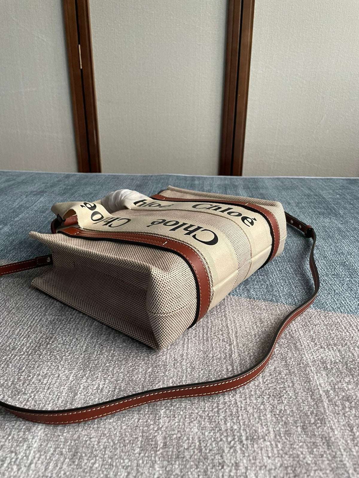 Small Strap Woody Tote Bag 26.5 in Beige Linen Canvas Black Webbing Logo Embroider Brown Calfskin