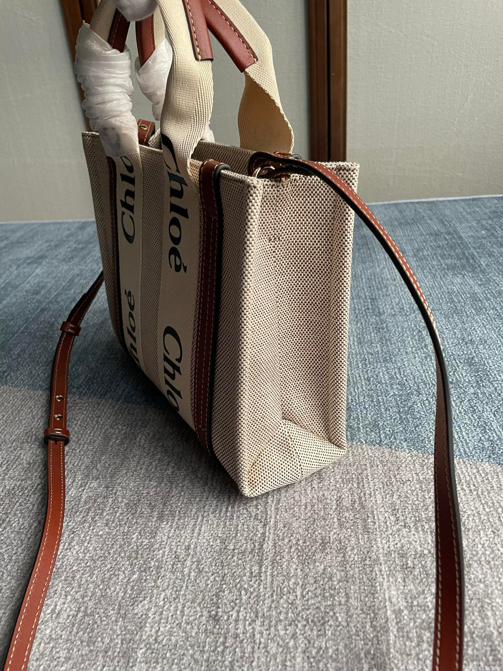 Small Strap Woody Tote Bag 26.5 in Beige Linen Canvas Black Webbing Logo Embroider Brown Calfskin