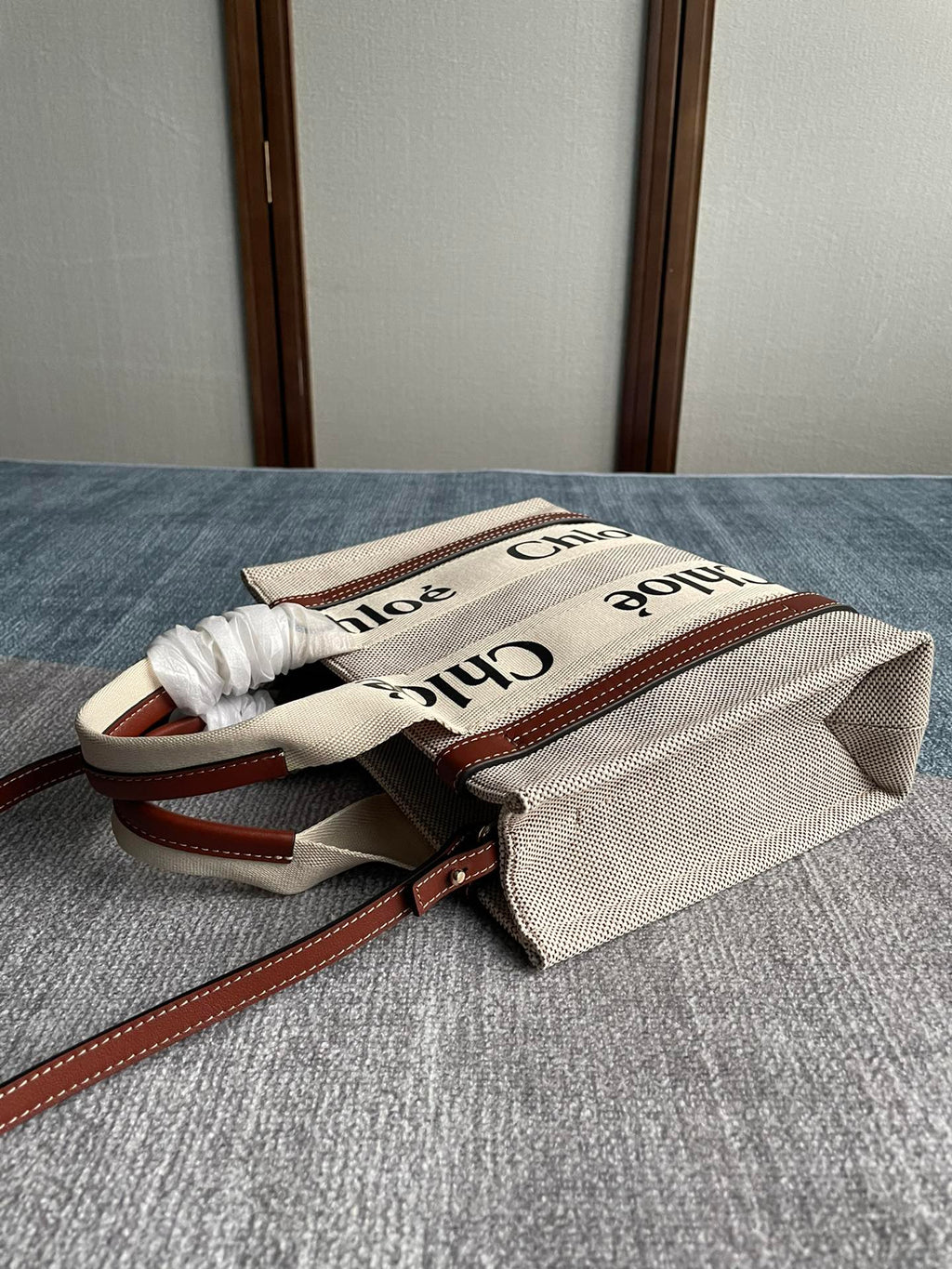 Small Strap Woody Tote Bag 26.5 in Beige Linen Canvas Black Webbing Logo Embroider Brown Calfskin