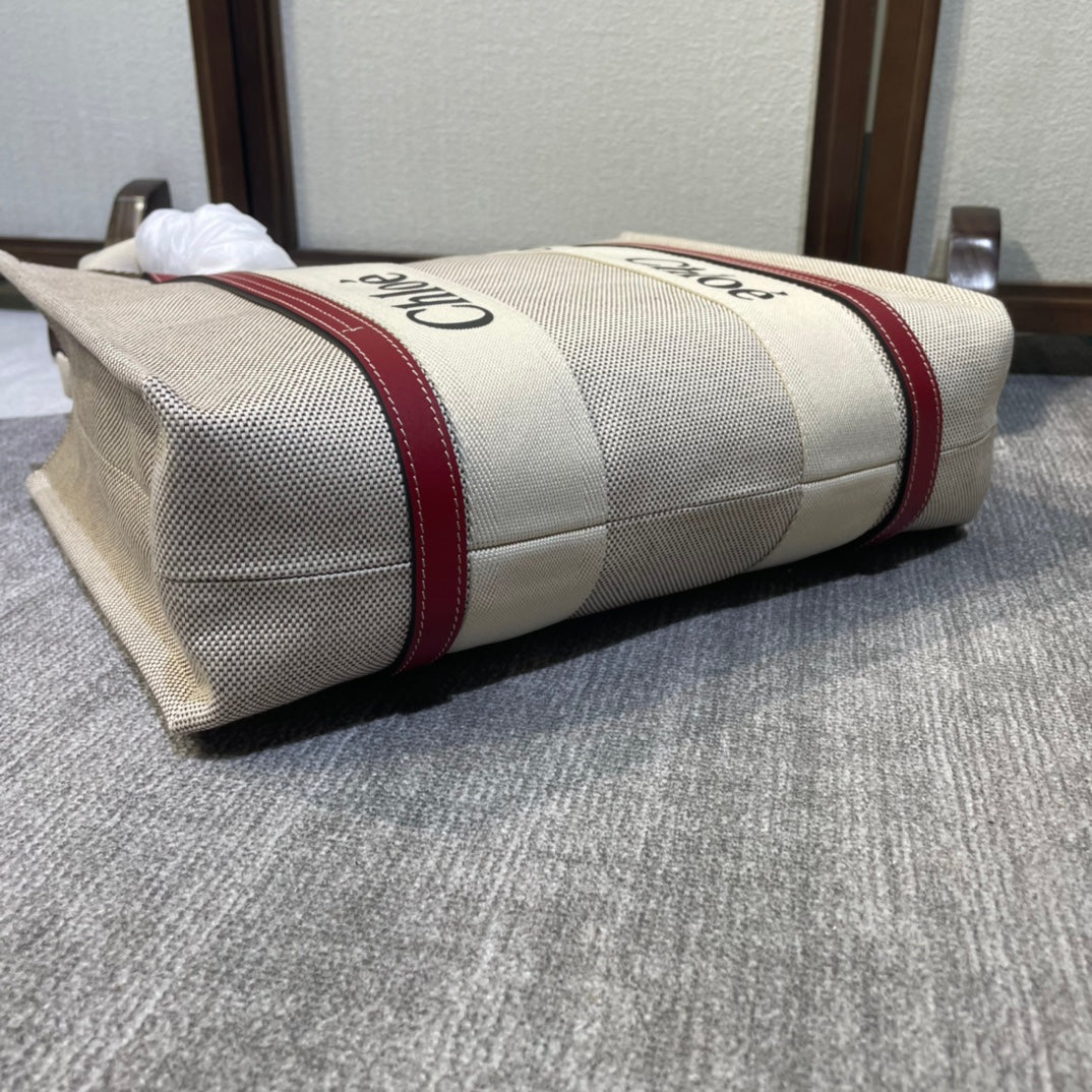 Medium Strap Woody Tote Bag 37 in Beige Linen Canvas Black Webbing Logo Embroider Red Calfskin
