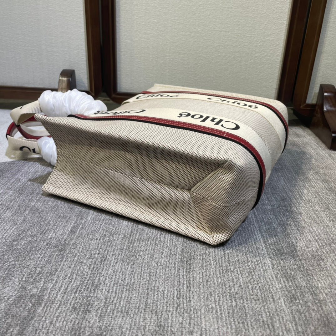 Medium Strap Woody Tote Bag 37 in Beige Linen Canvas Black Webbing Logo Embroider Red Calfskin