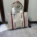Medium Strap Woody Tote Bag 37 in Beige Linen Canvas Black Webbing Logo Embroider Red Calfskin