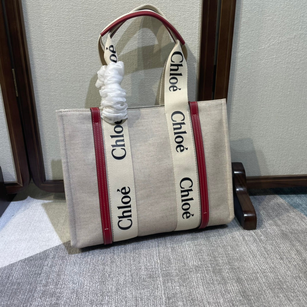 Medium Strap Woody Tote Bag 37 in Beige Linen Canvas Black Webbing Logo Embroider Red Calfskin